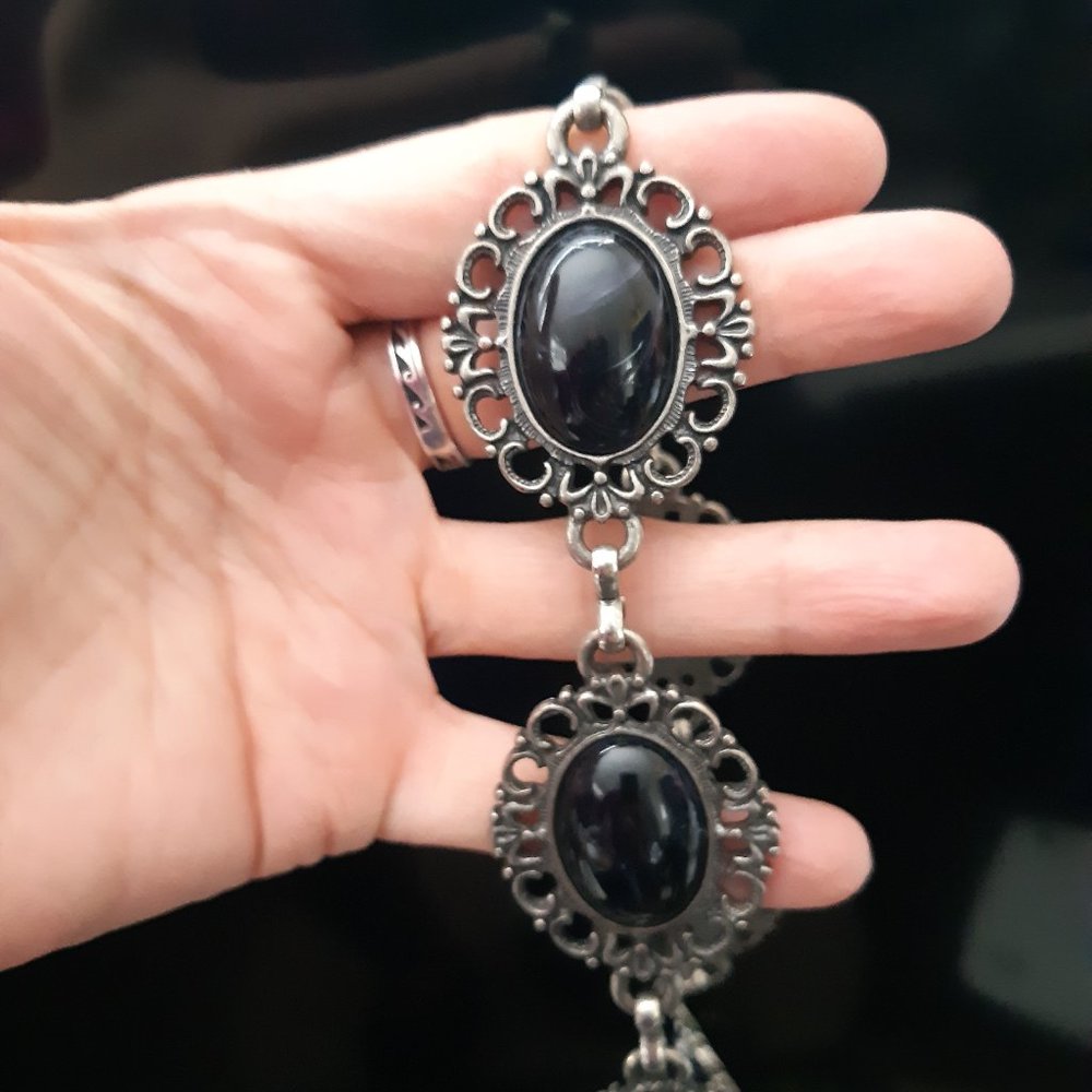 Womens belt. With black Jeweled Emblems.